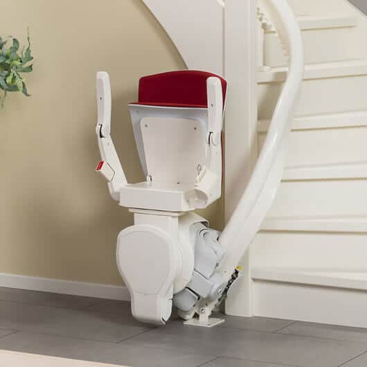 Curved stairlift red seat folded