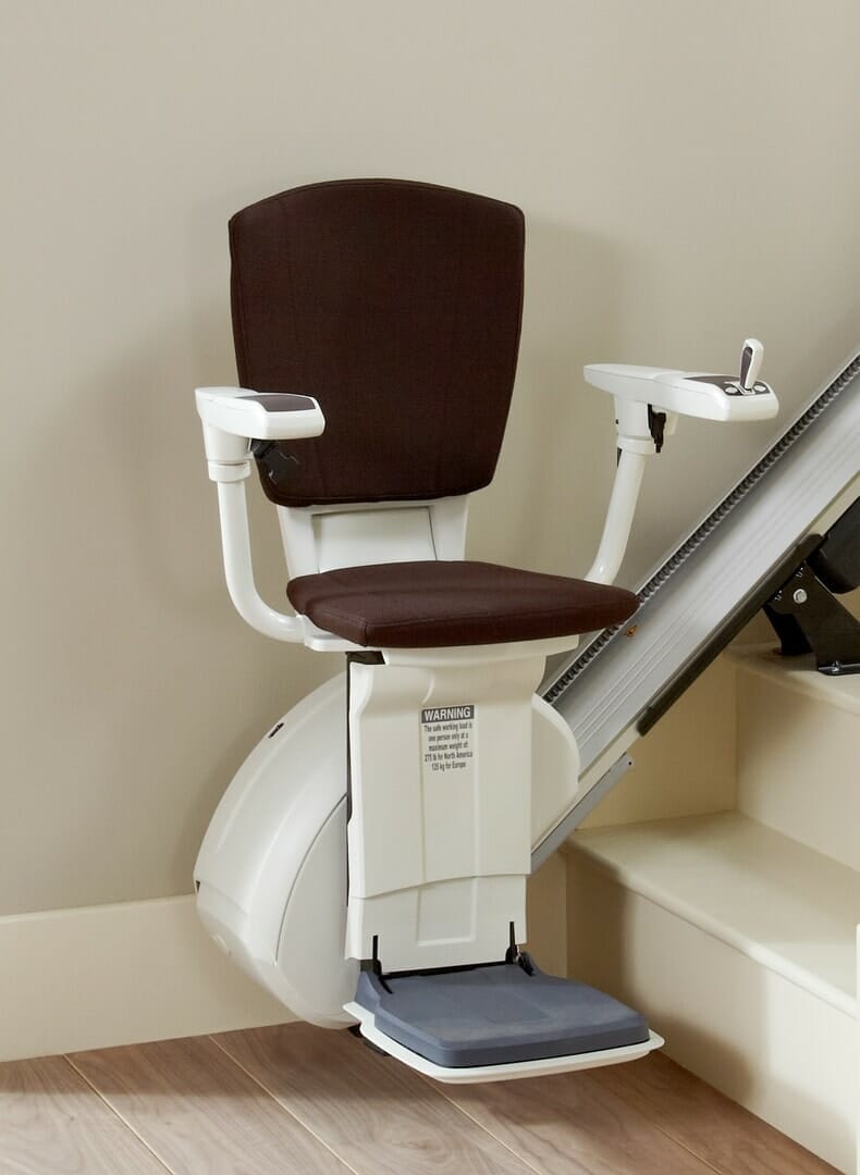 homeglide extra stairlift brown seat at bottom of stairs close up