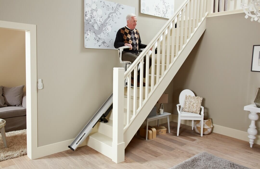 homeglide extra stairlift man half way up stairs travelling on lift 1