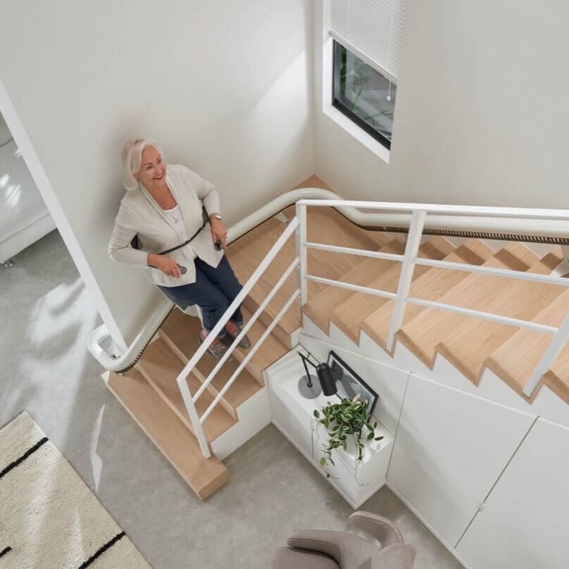 curved stairlift travelling up stairs